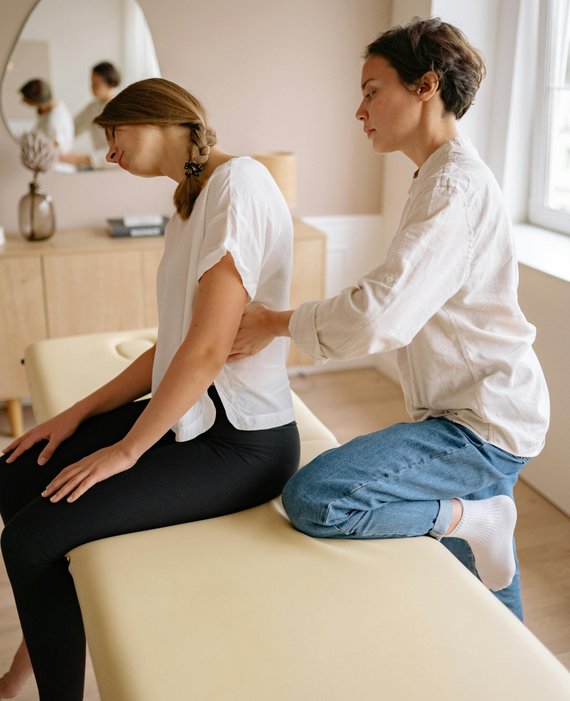 a therapist massaging a woman's back